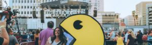 woman taking photo with Pac man at lost 80’s live