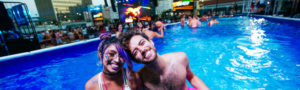 couple in pool at collective zoo party