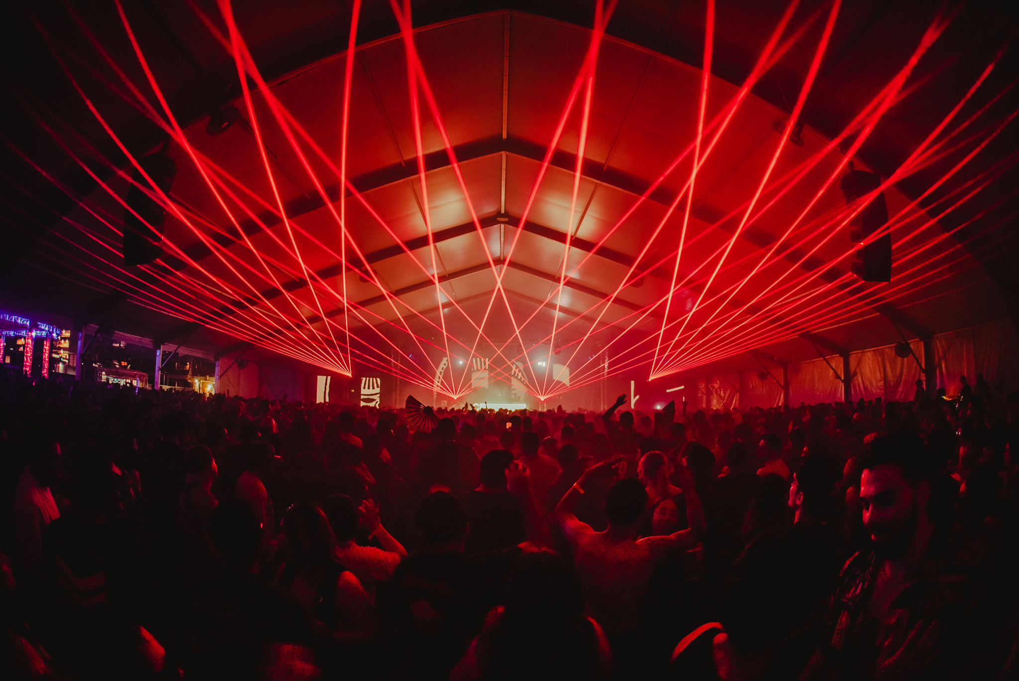 Red lasers fill the tent during the event.